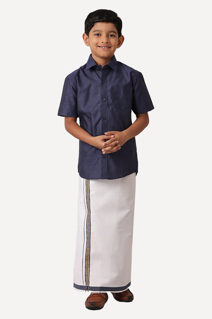 A boy wearing a navy blue shirt and white dhoti with a regular fit.