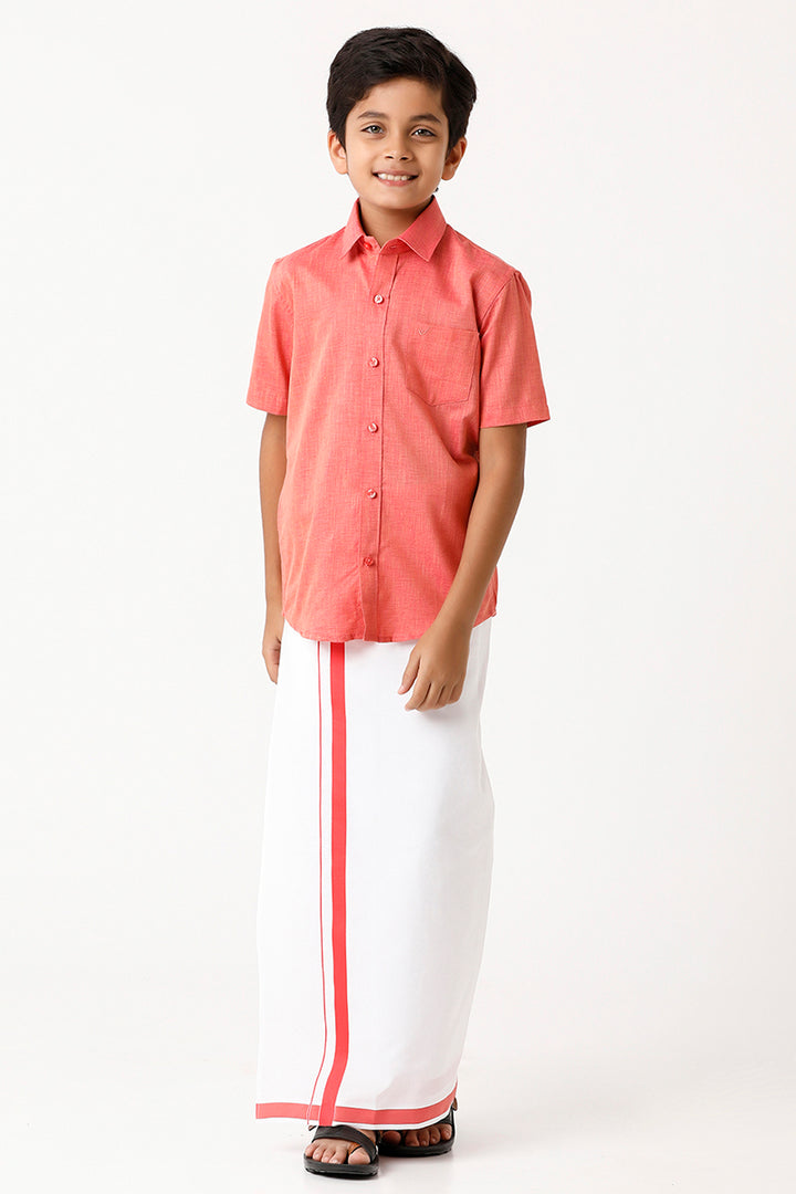 A child wearing a dark rose shirt and a matching fixit dhoti.