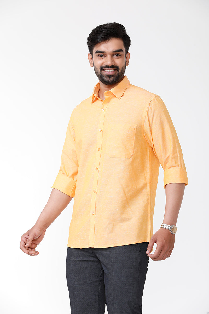 A man wearing an orange yellow formal shirt with a collar, button-up front, and long sleeves.