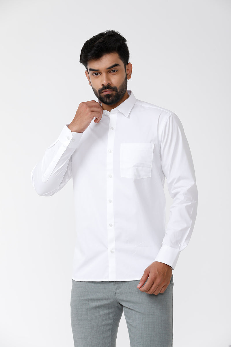 A man wearing a crisp white cotton formal shirt with a regular collar and cuffs. The shirt has a regular fit and arrow cut at the bottom.