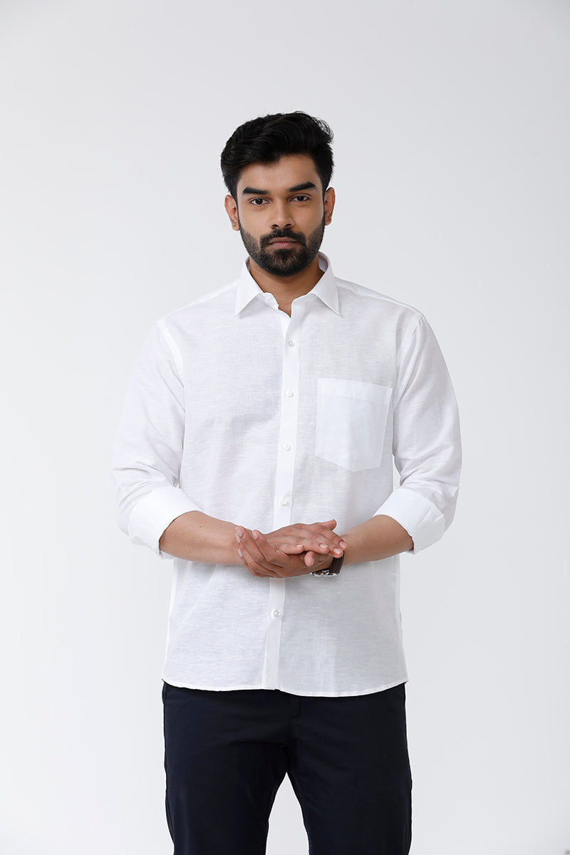 A man wearing a white linen cotton shirt with a regular fit and apple cut bottom, displaying the shirt's collar and sleeve length.