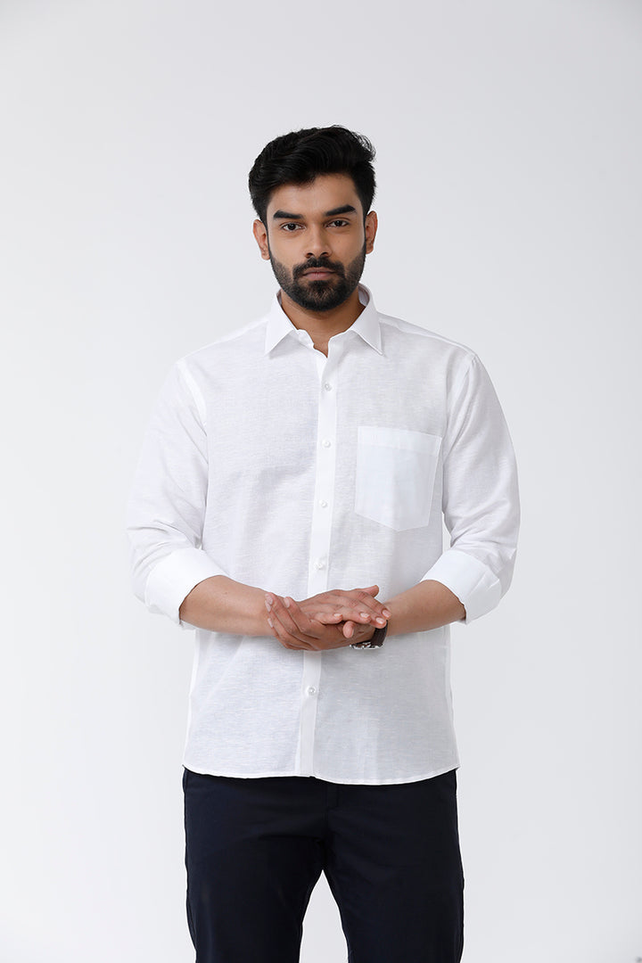 A man wearing a white linen cotton shirt with a regular fit and apple cut bottom, displaying the shirt's collar and sleeve length.