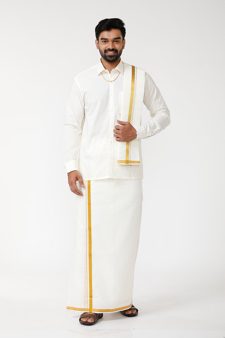 A man wearing a cream-colored cotton shirt, a double layered dhoti with a towel, and a matching belt, posing against a grey background.