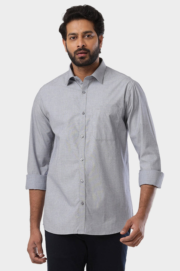 A man wearing a charcoal black formal shirt with full sleeves and a smart fit.
