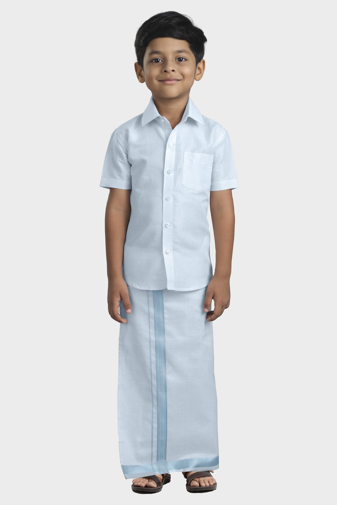 A kid wearing a cyan blue shirt and matching dhoti .
