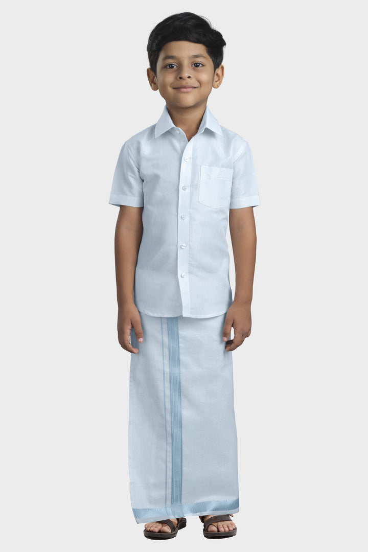 A kid wearing a cyan blue shirt and matching dhoti .