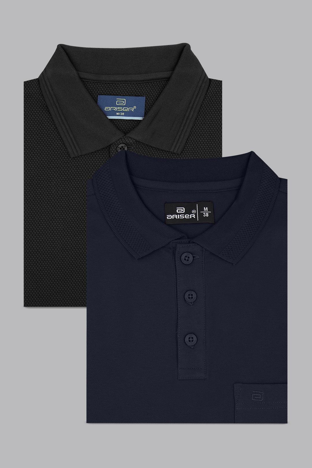 Two folded polo shirts, one black and one navy, on a gray background.