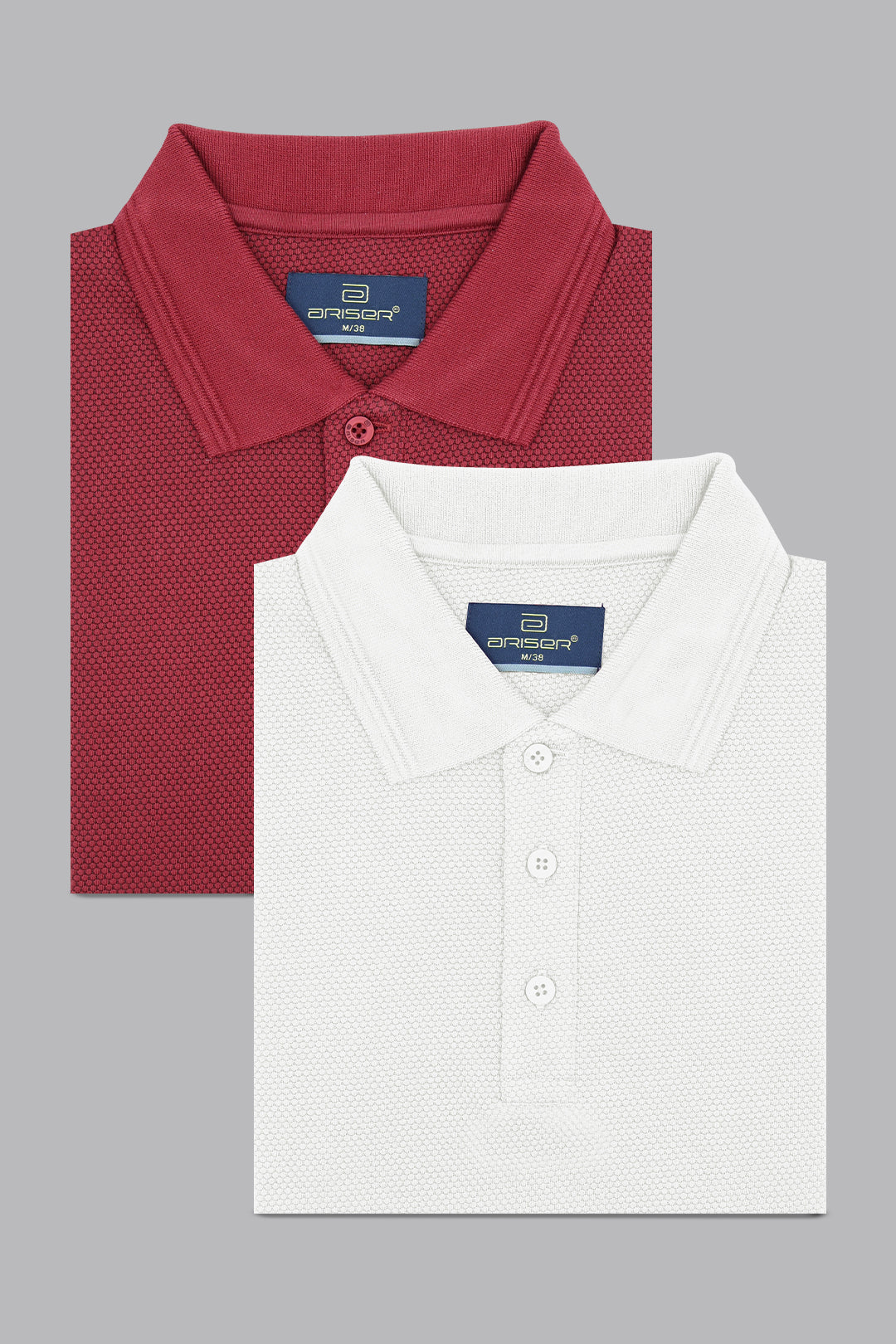 Two folded polo shirts, one red and one white, on a gray background.