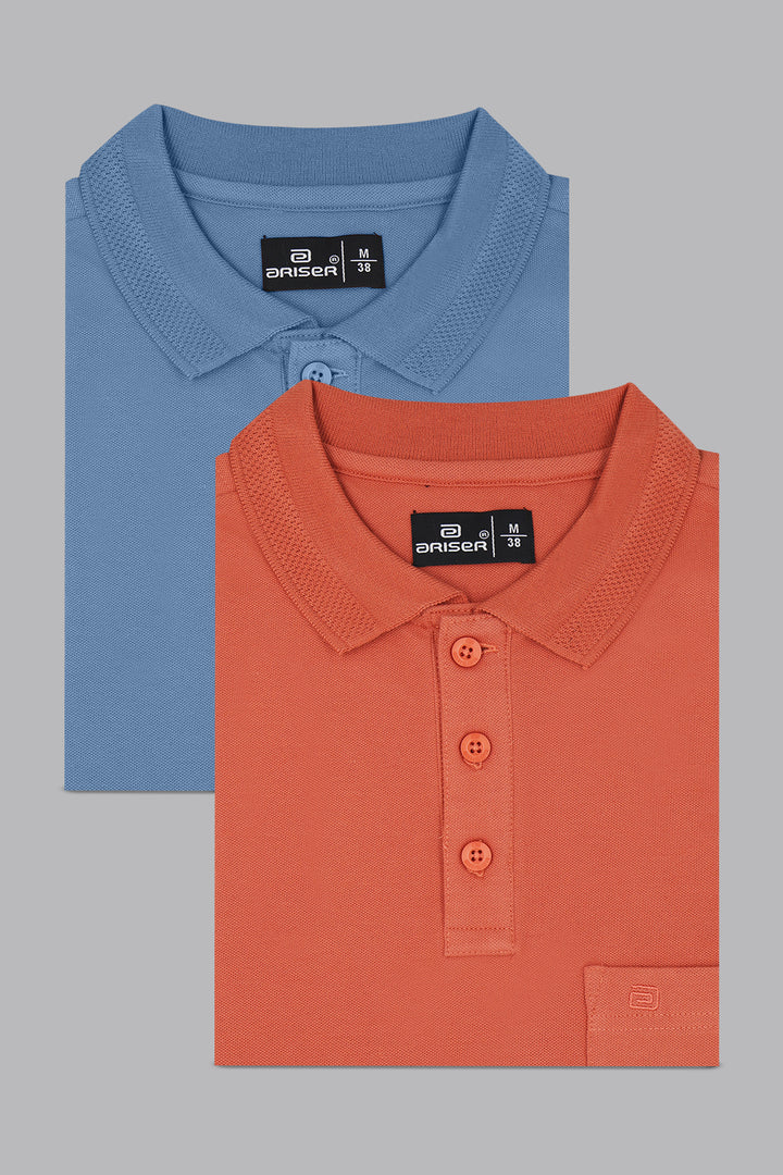 Two folded polo shirts, one blue and one orange, on a gray background.