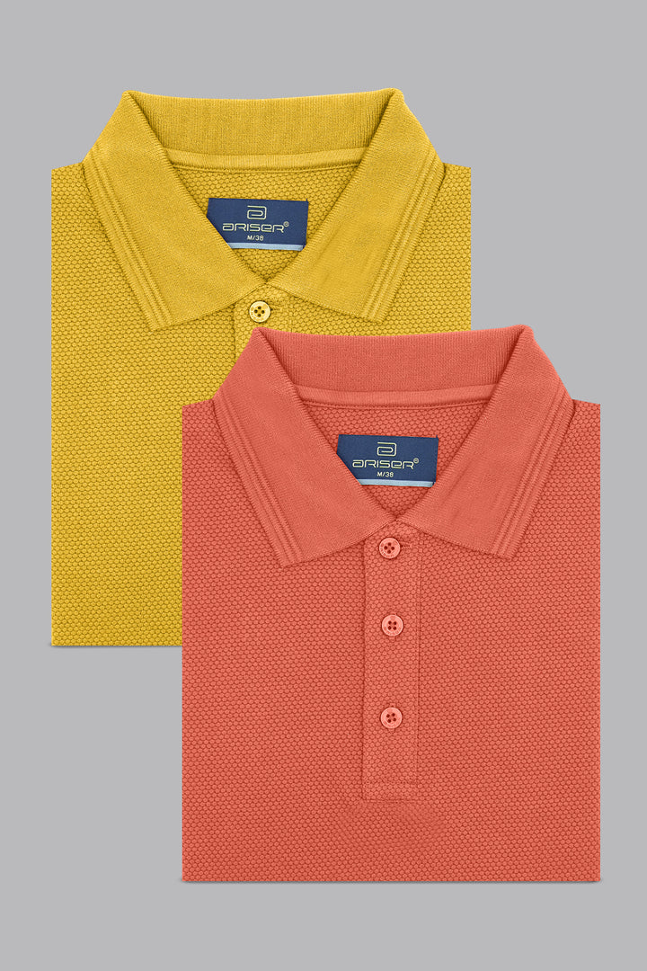 Two folded polo shirts, one yellow and one red, on a gray background.