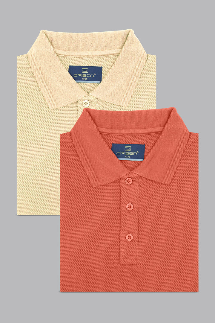 Two folded polo T-shirts, one beige and one coral, on a gray background.
