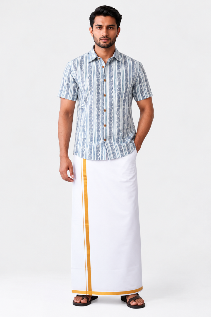 A man modeling a traditional South Asian outfit consisting of a light blue and white vertically striped short-sleeve button-up shirt and a white drape (kurti) with a gold border, paired with black sandals, against a plain light gray background.