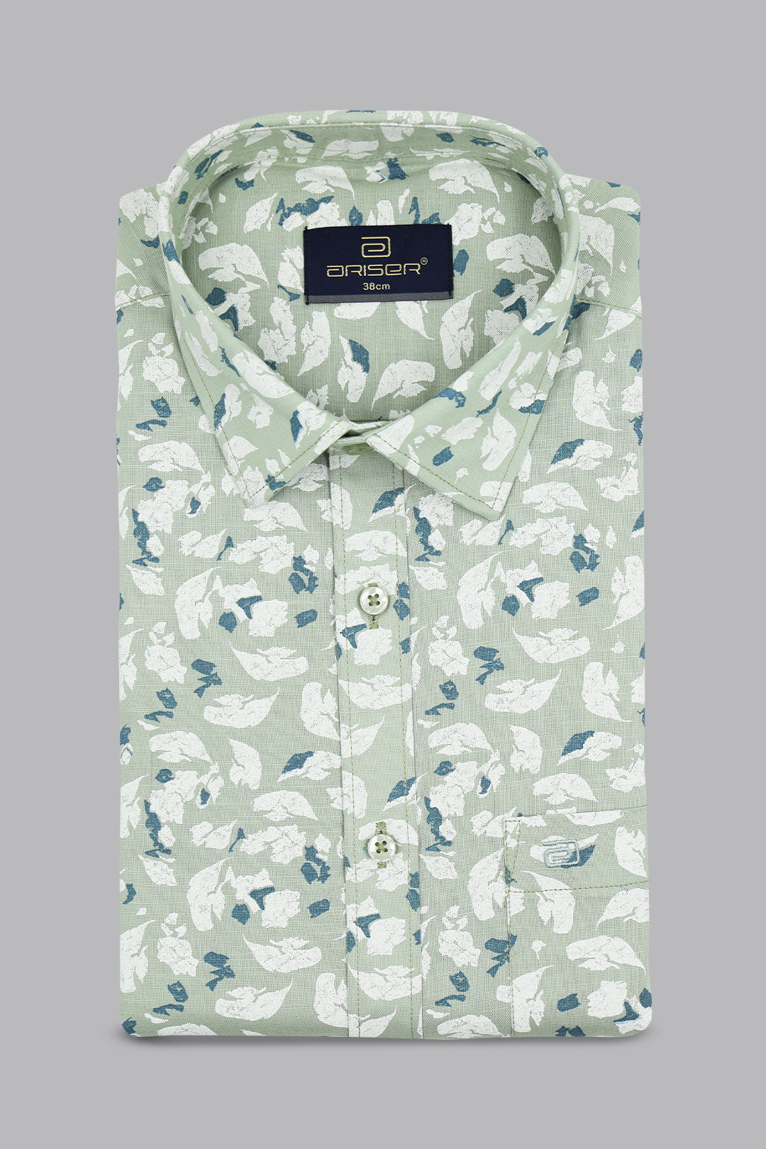 Green shirt with white floral pattern on a gray background