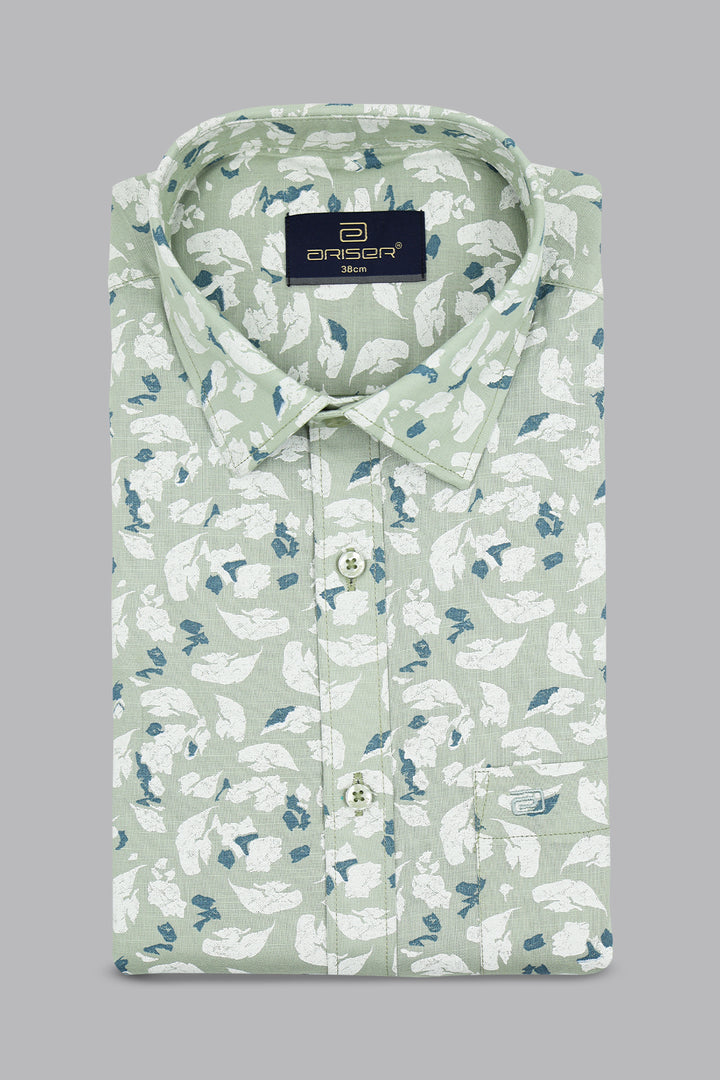 Green shirt with white floral pattern on a gray background