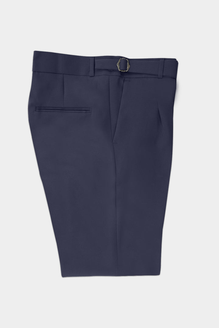 A pair of navy blue tailored shorts with a front button closure, belt loop, and a side welt pocket, shown flat against a light gray background.