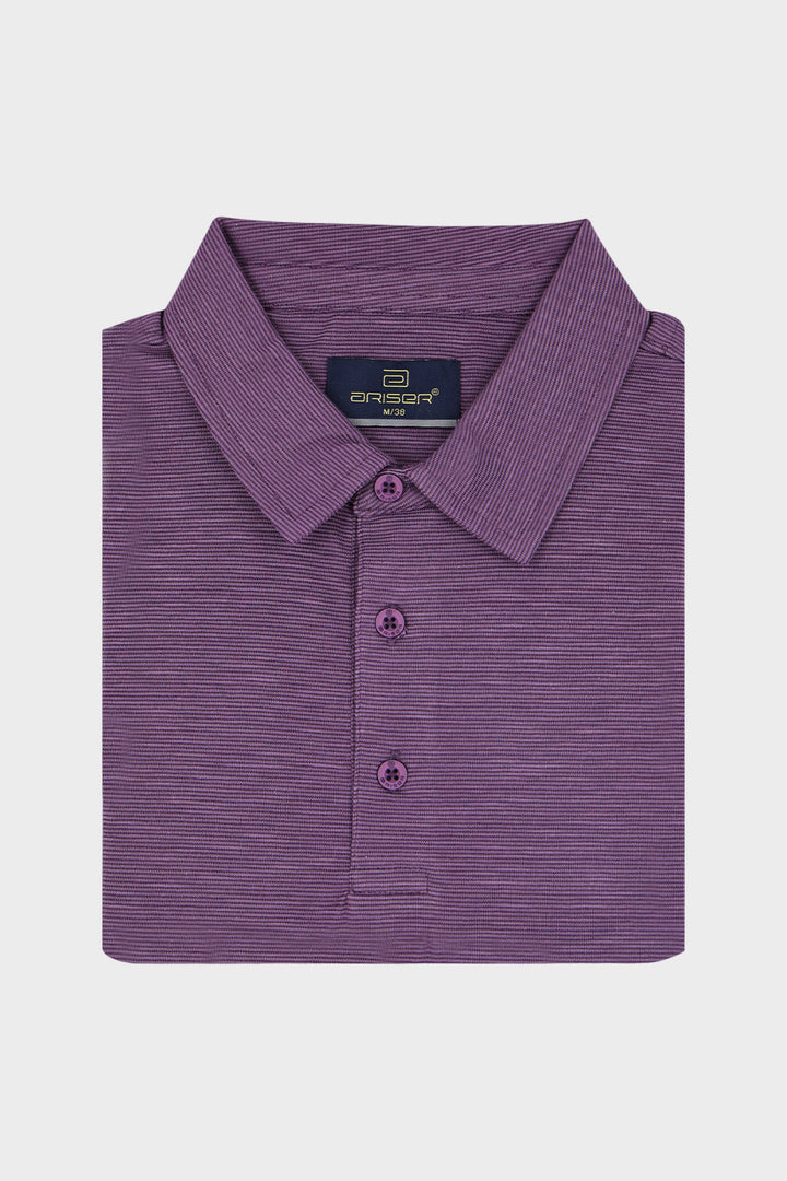 A folded purple polo shirt with a textured, fine horizontal stripe pattern, featuring a collar and three buttons, displayed on a light gray background.