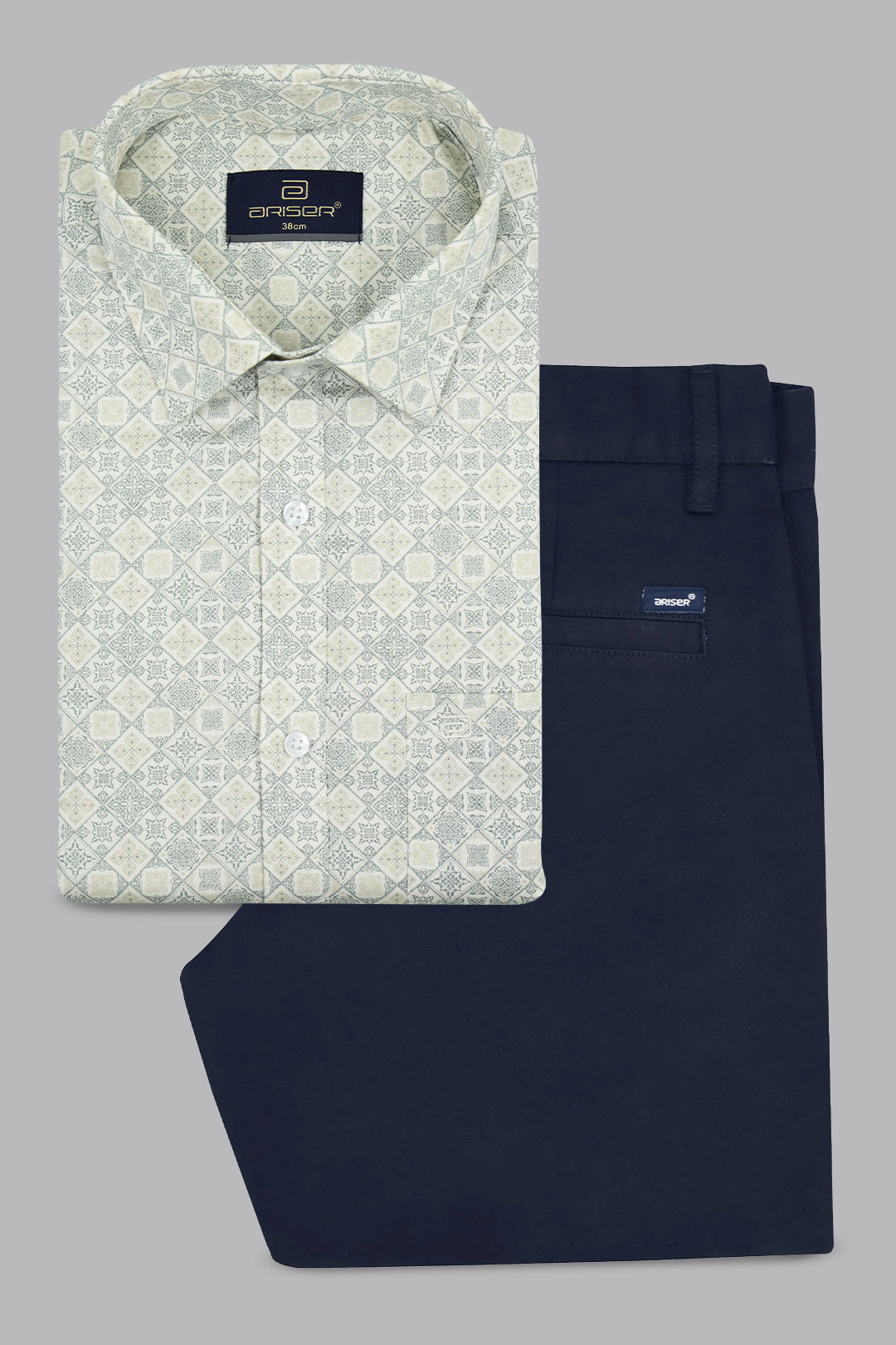 Folded patterned shirt and navy pants on a gray background
