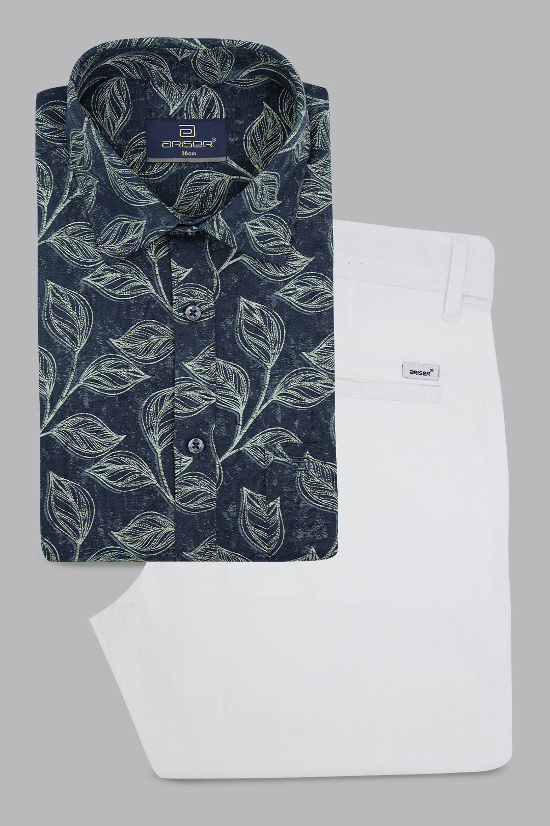 Blue patterned shirt and white pants on a gray background