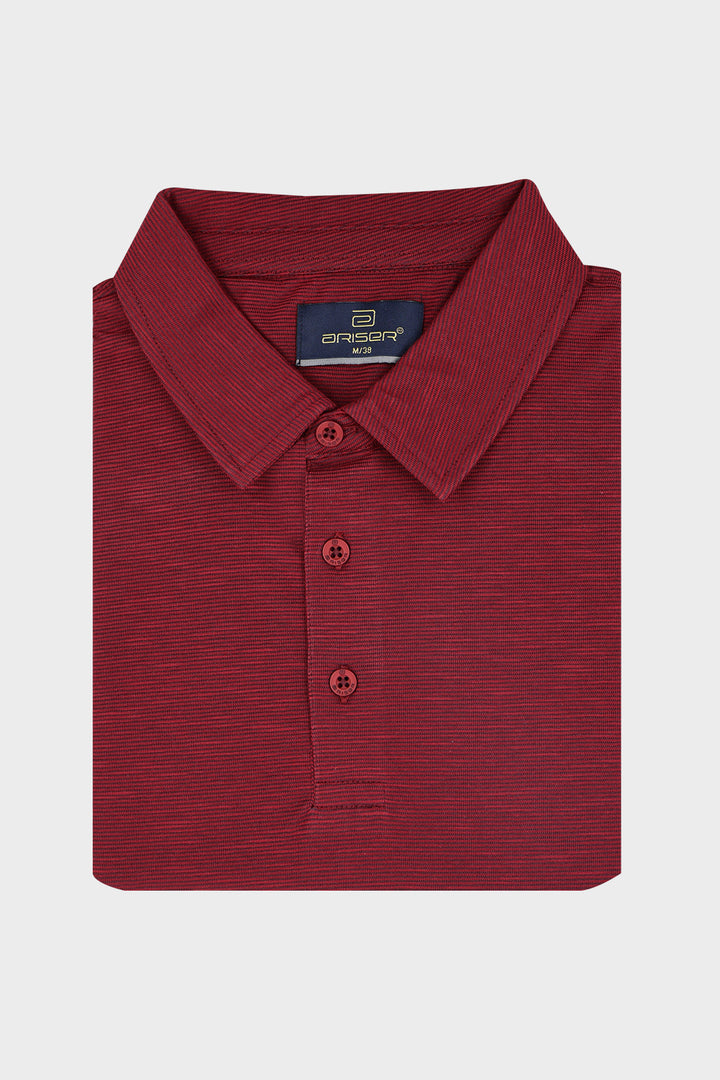 A folded men's polo shirt in a heathered dark red color, featuring a classic collar, three-button.