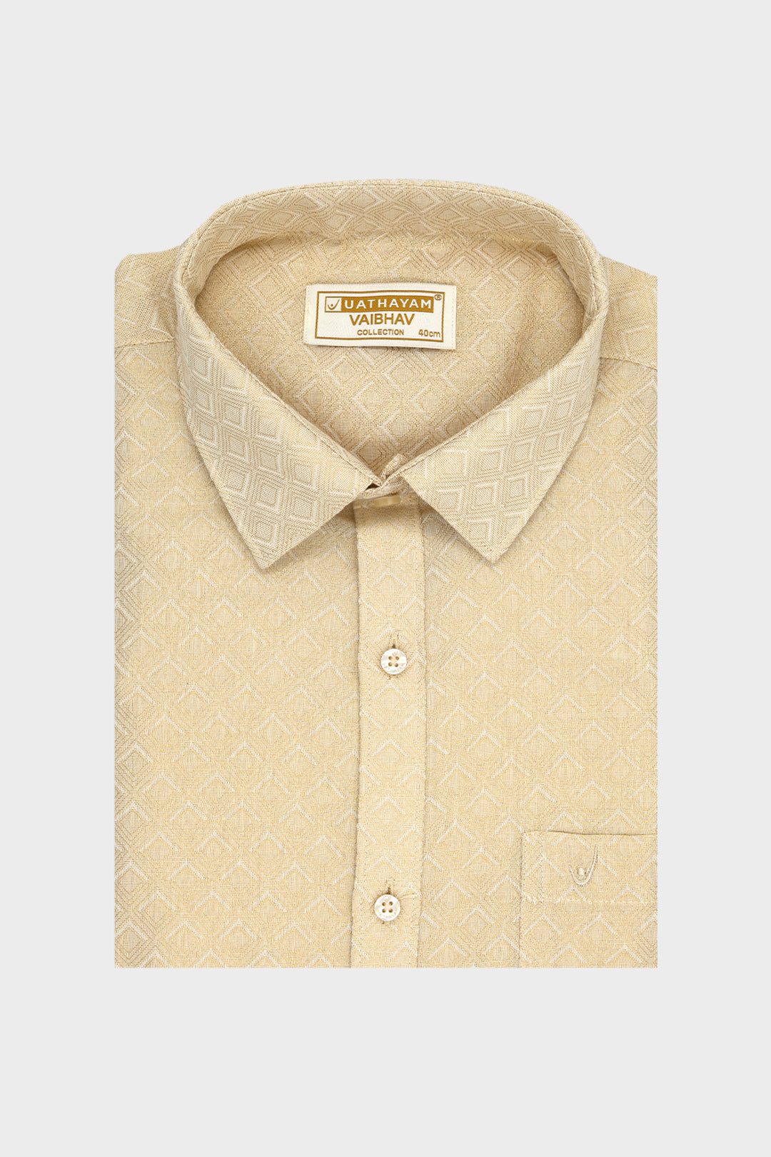 A folded beige dress shirt with a subtle geometric pattern, featuring a pointed collar, button-down front, and a visible neck label for 'VAIBHAV'.