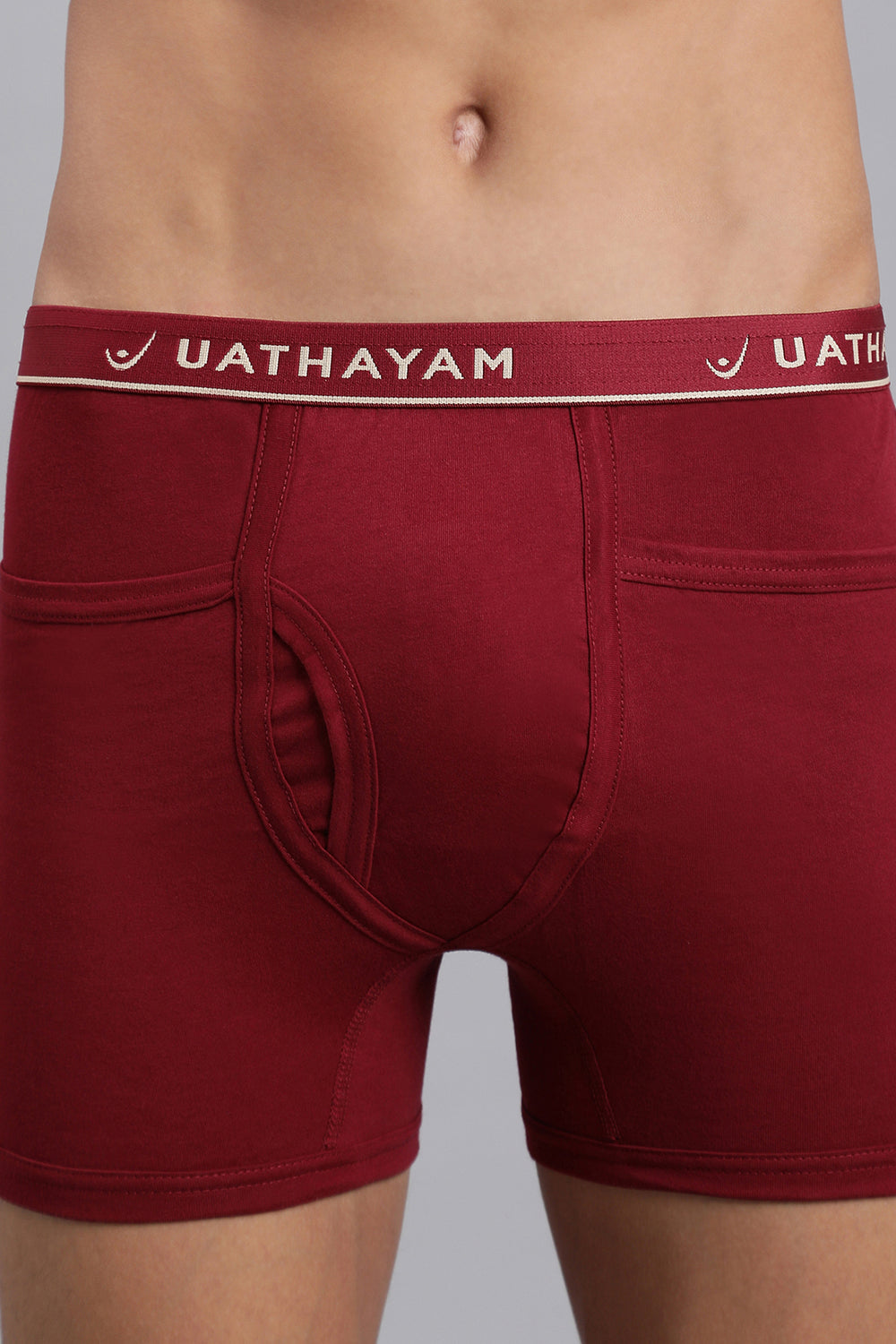 Red boxer briefs with a visible brand logo on a gray background
