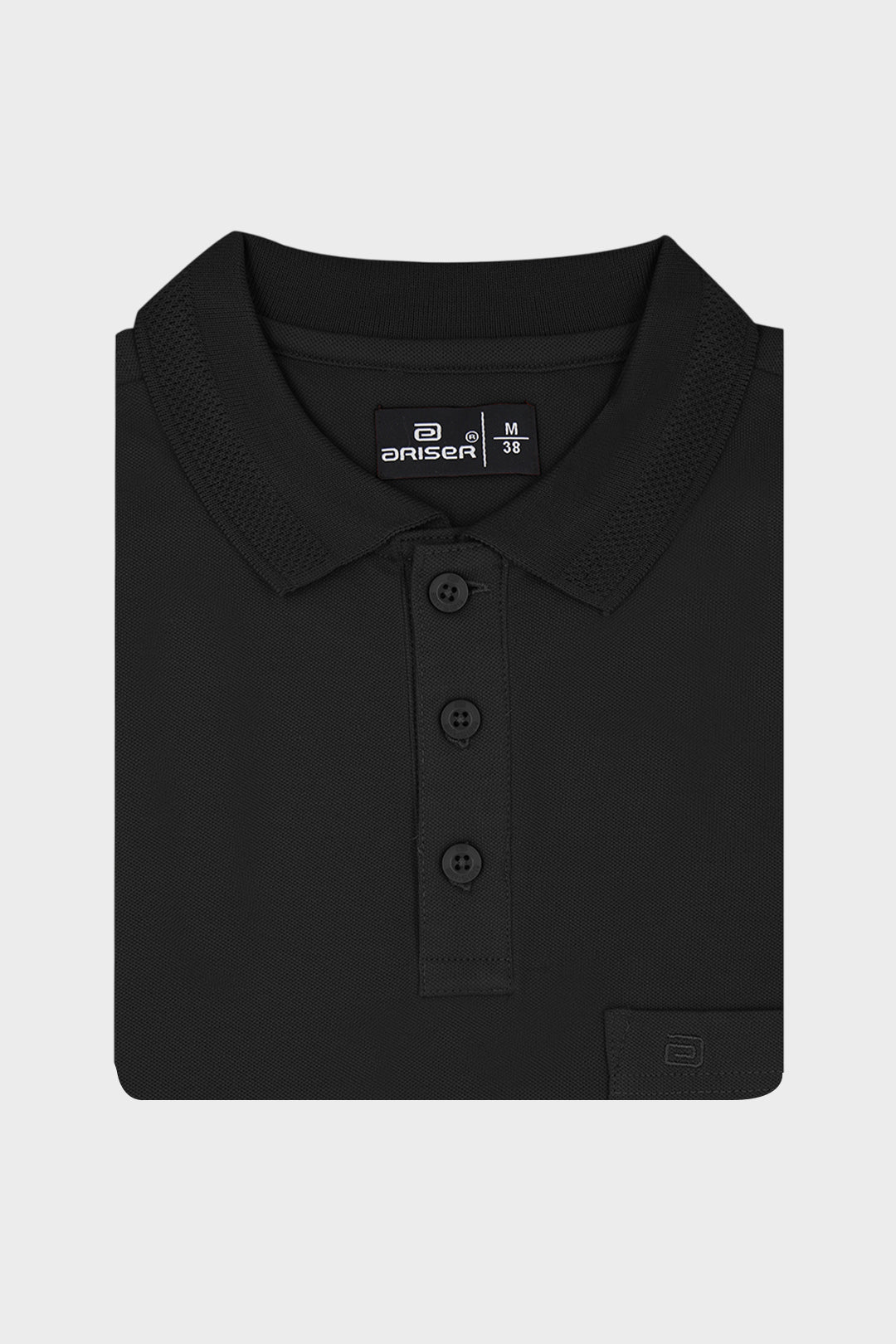 A folded black polo shirt with a three-button placket and a small brand label on the inner neck, displayed on a light gray background.