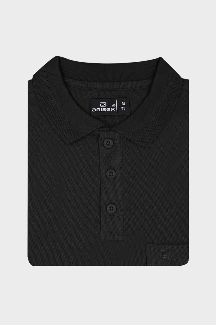 A folded black polo shirt with a three-button placket and a small brand label on the inner neck, displayed on a light gray background.