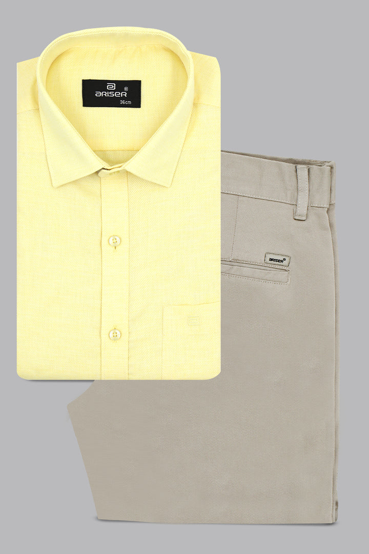 Yellow shirt and beige pants on a gray background