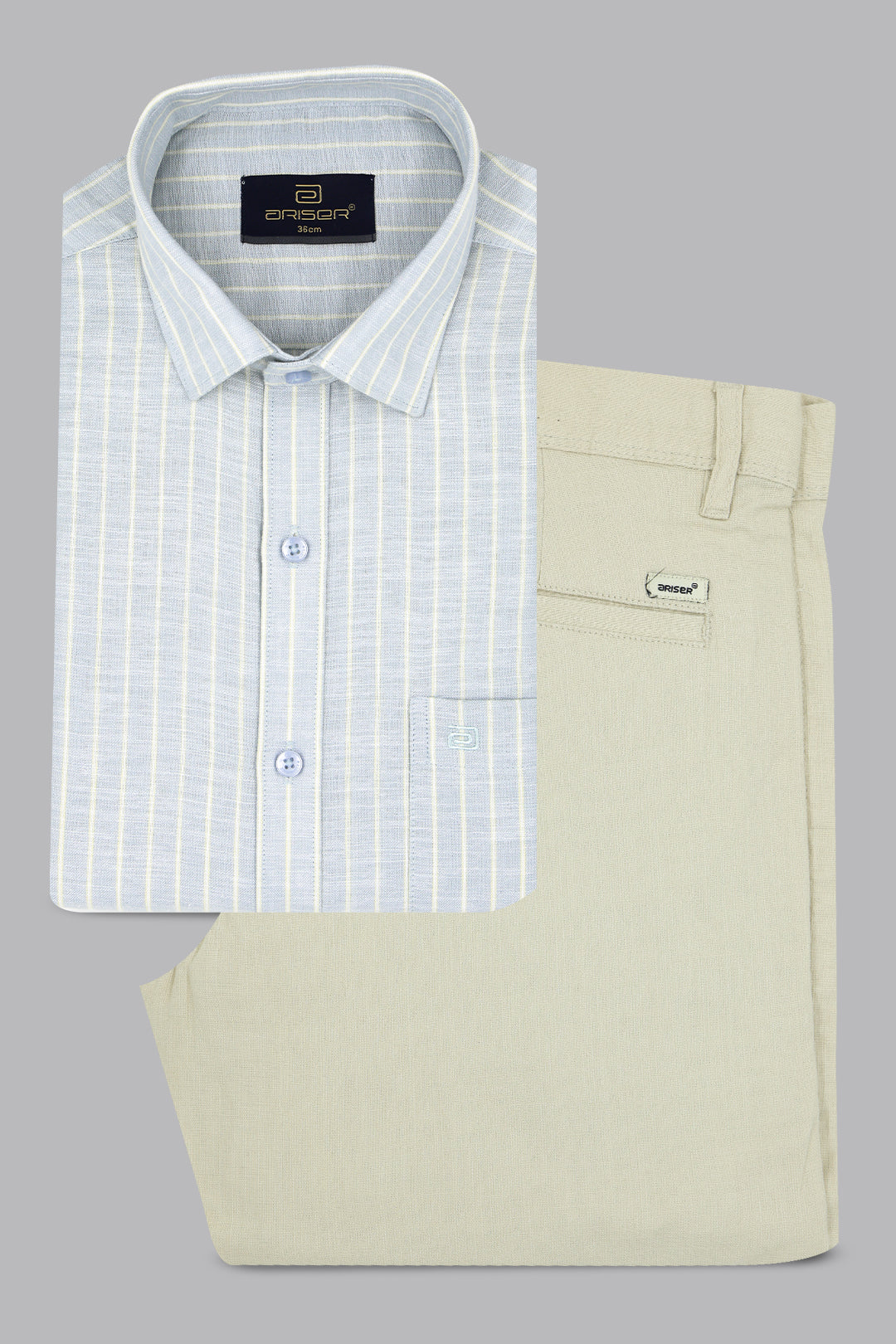 Folded light blue checkered shirt and beige pants on a gray background