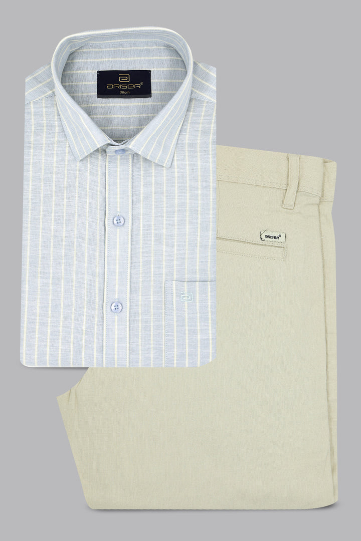 Folded light blue checkered shirt and beige pants on a gray background