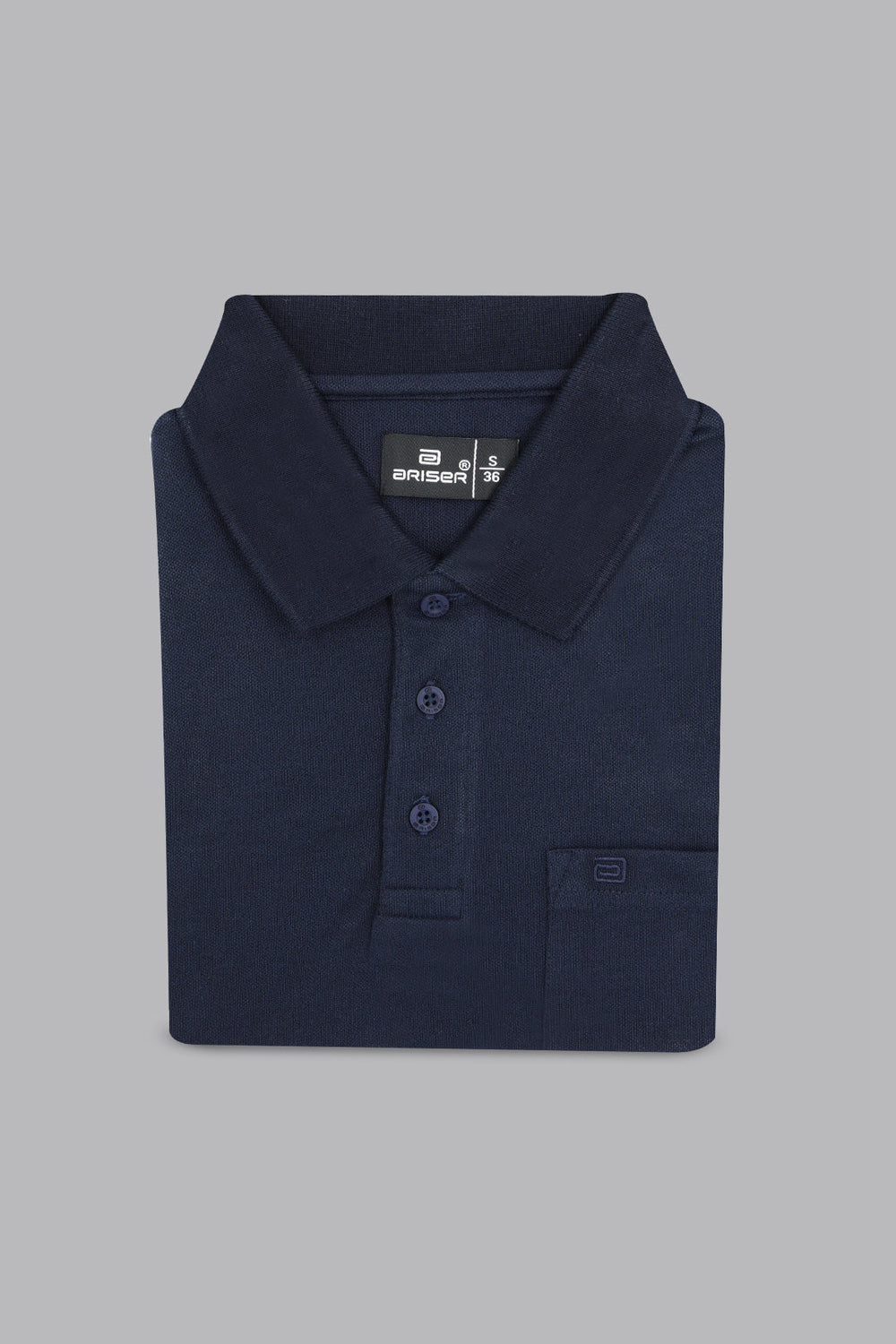 Folded navy blue polo shirt on a gray background