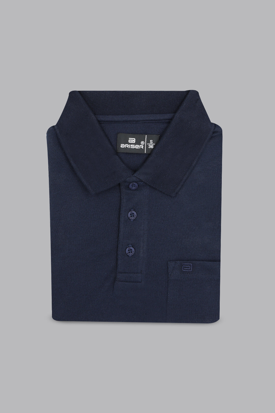 Folded navy blue polo shirt on a gray background