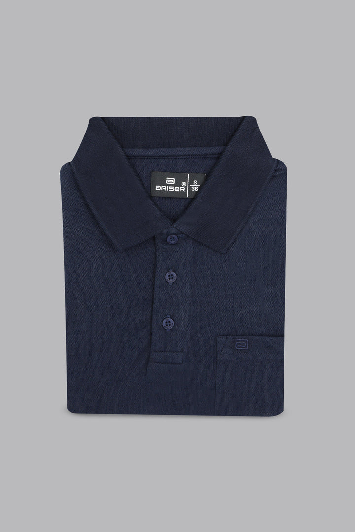 Folded navy blue polo shirt on a gray background