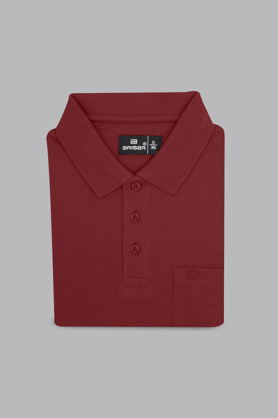 Folded maroon polo shirt with a brand label on a gray background