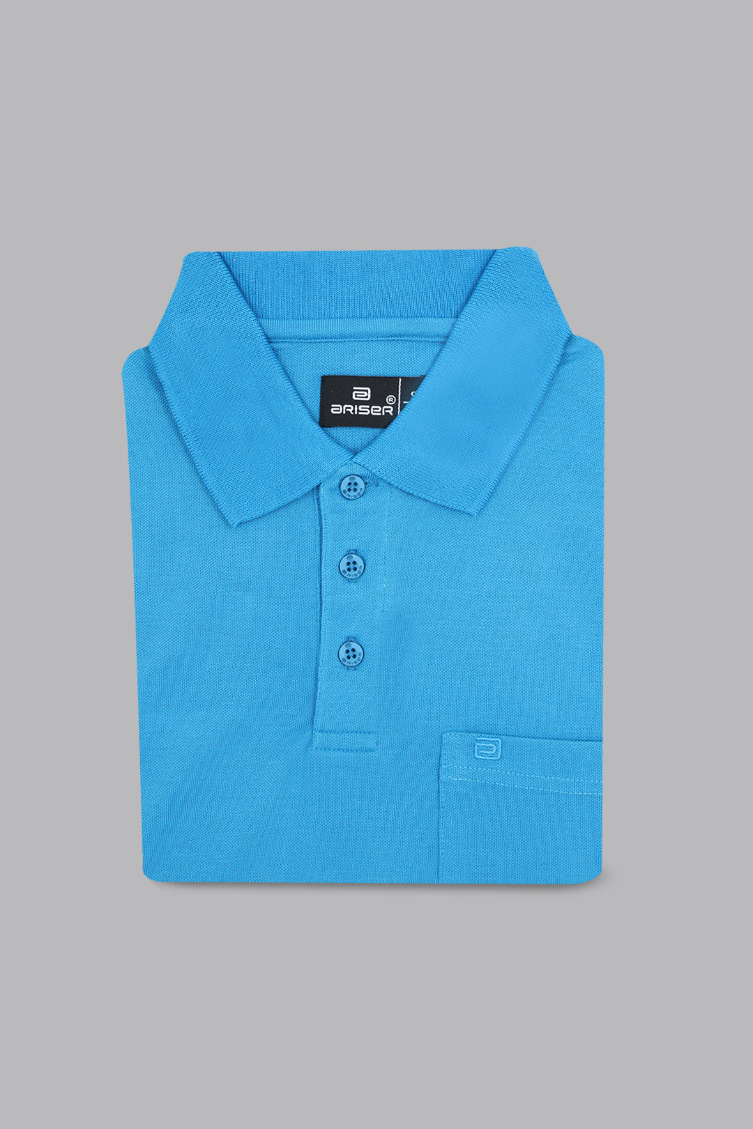 Folded blue polo shirt with a brand label on a gray background