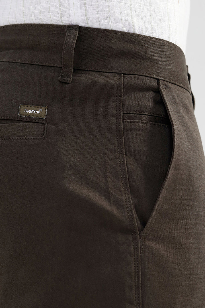 Brown pants with a brand label on a plain background