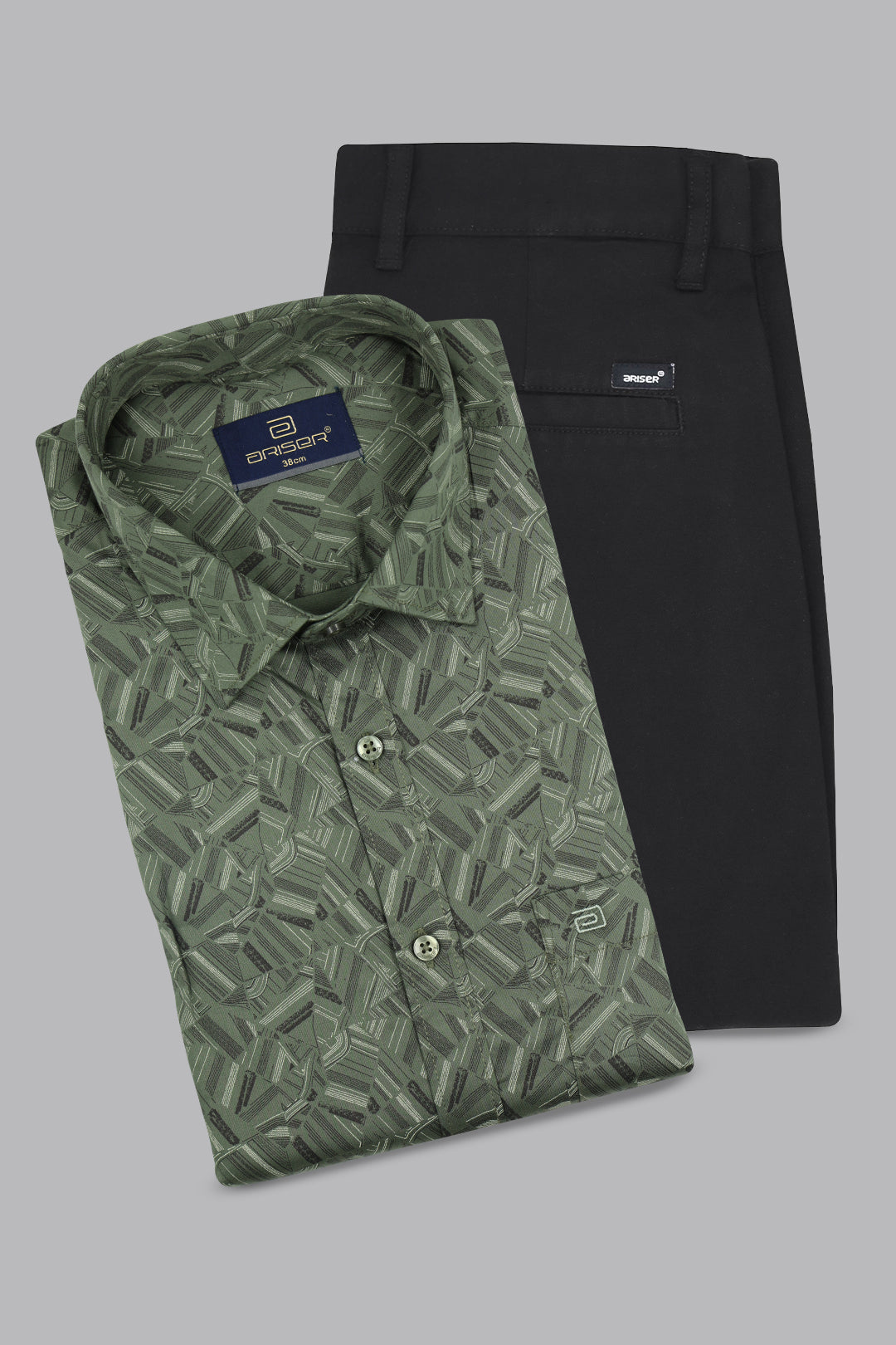 Green patterned shirt and black pants on a gray background