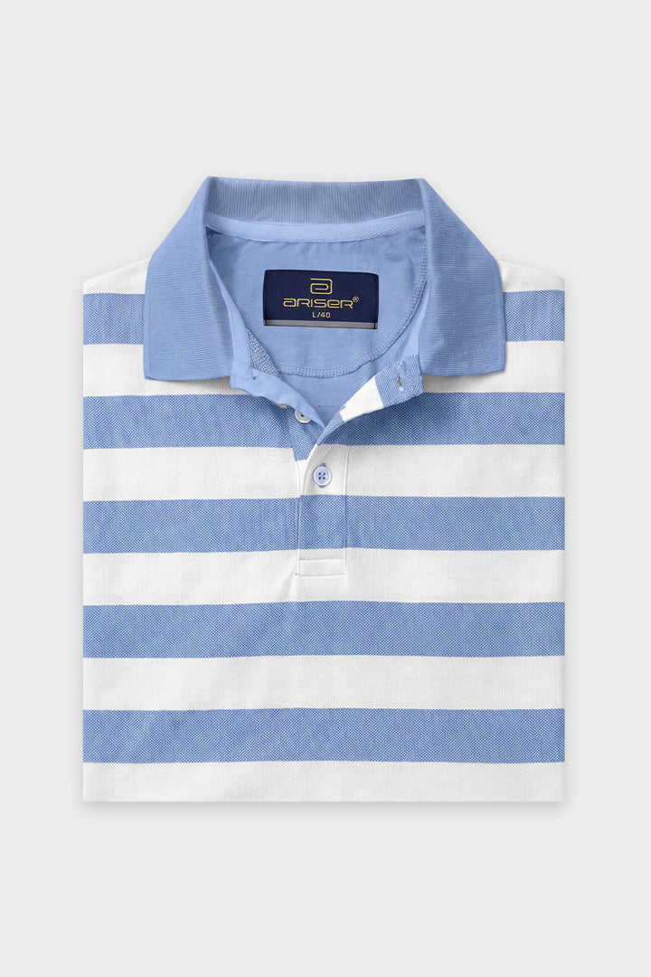 A folded light blue and white striped polo shirt with a navy blue brand label on the collar, displayed against a light gray background.