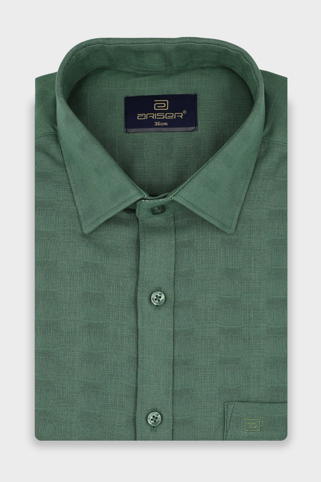 A folded green long-sleeve dress shirt with a textured pattern, featuring a pointed collar, button-down front, and a visible Ariser neck label.