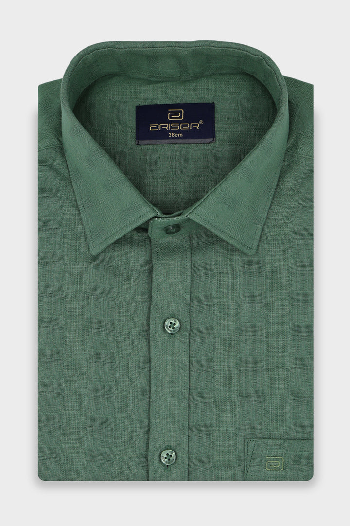 A folded green long-sleeve dress shirt with a textured pattern, featuring a pointed collar, button-down front, and a visible Ariser neck label.