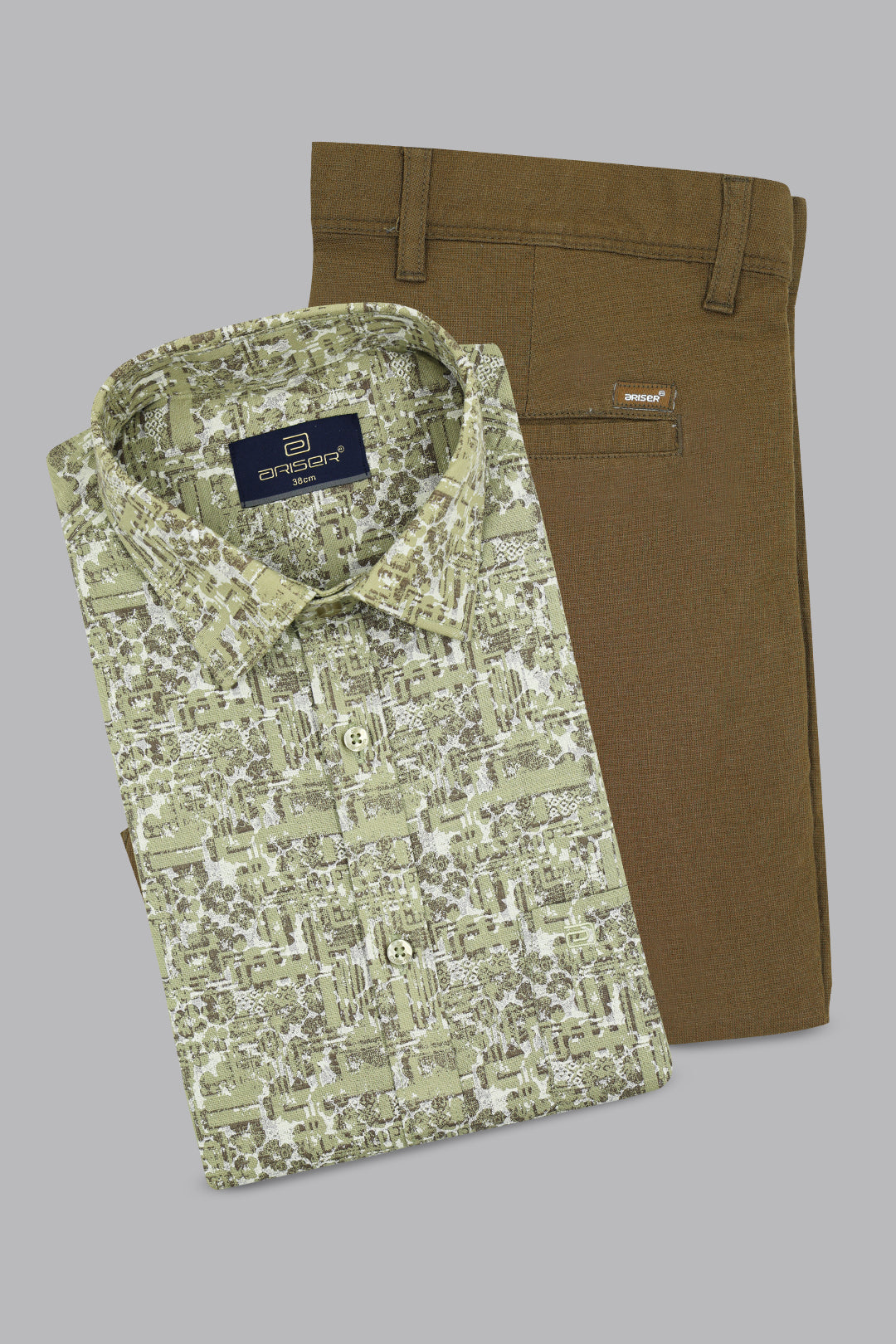 Green patterned shirt and brown pants on a gray background