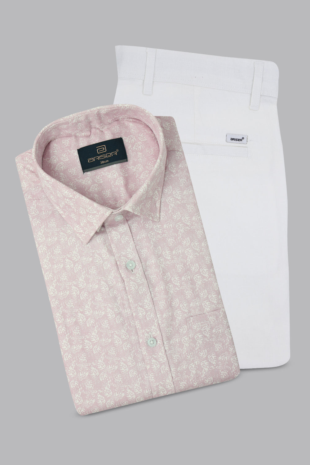 Two folded shirts, one pink with a subtle pattern and one white, on a gray background.