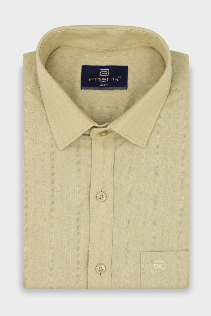 A folded beige long-sleeve dress shirt 