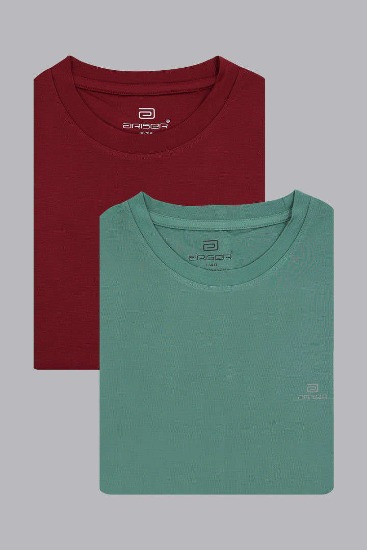 Two folded t-shirts, one red and one green, on a gray background.