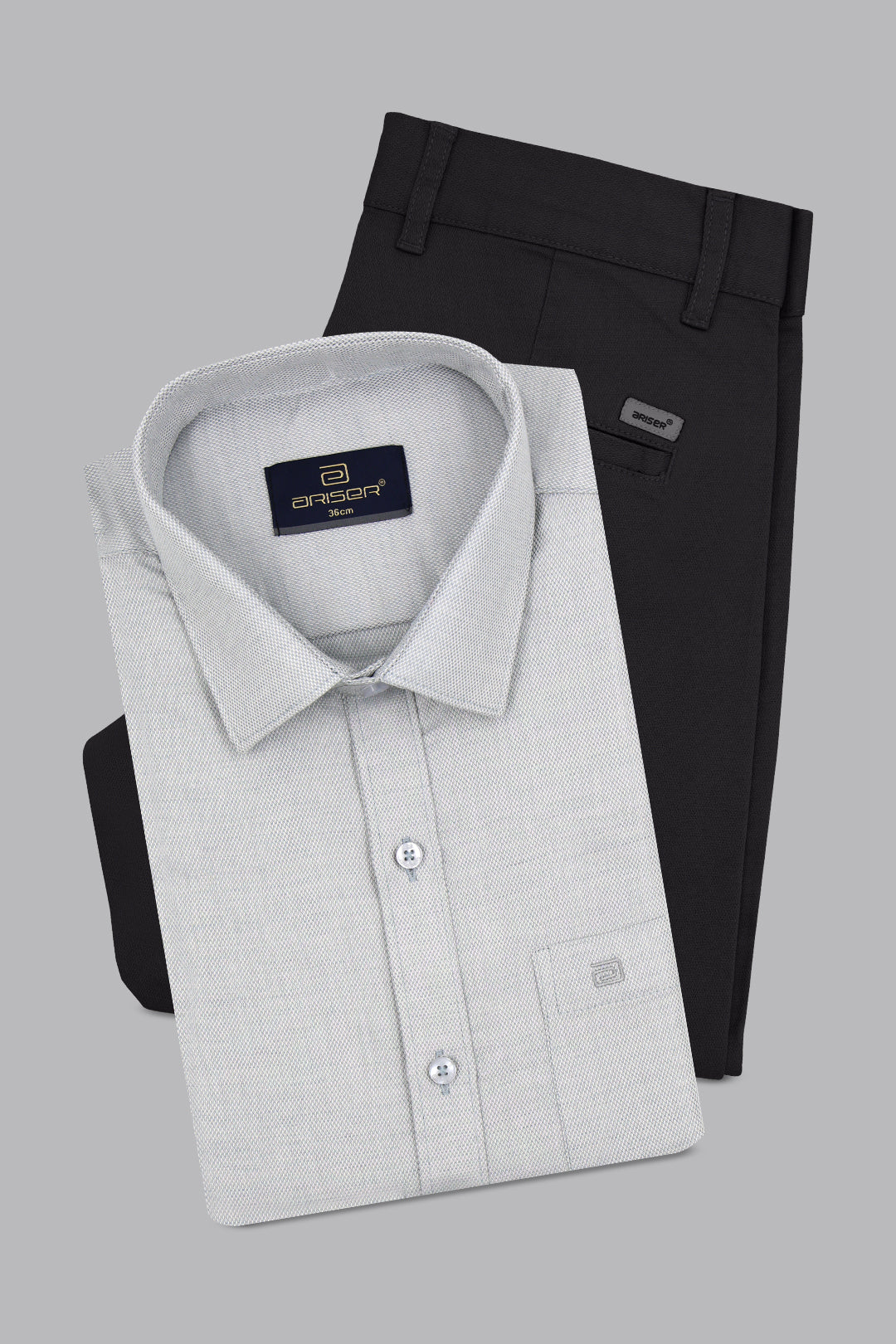 Gray dress shirt and black pants on a gray background