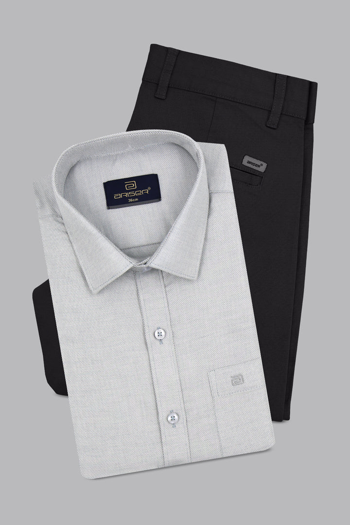 Gray dress shirt and black pants on a gray background