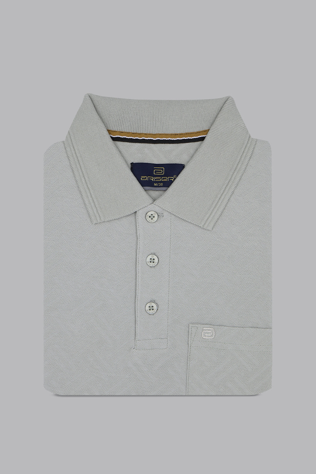 Folded light gray polo shirt with brand logo on a gray background
