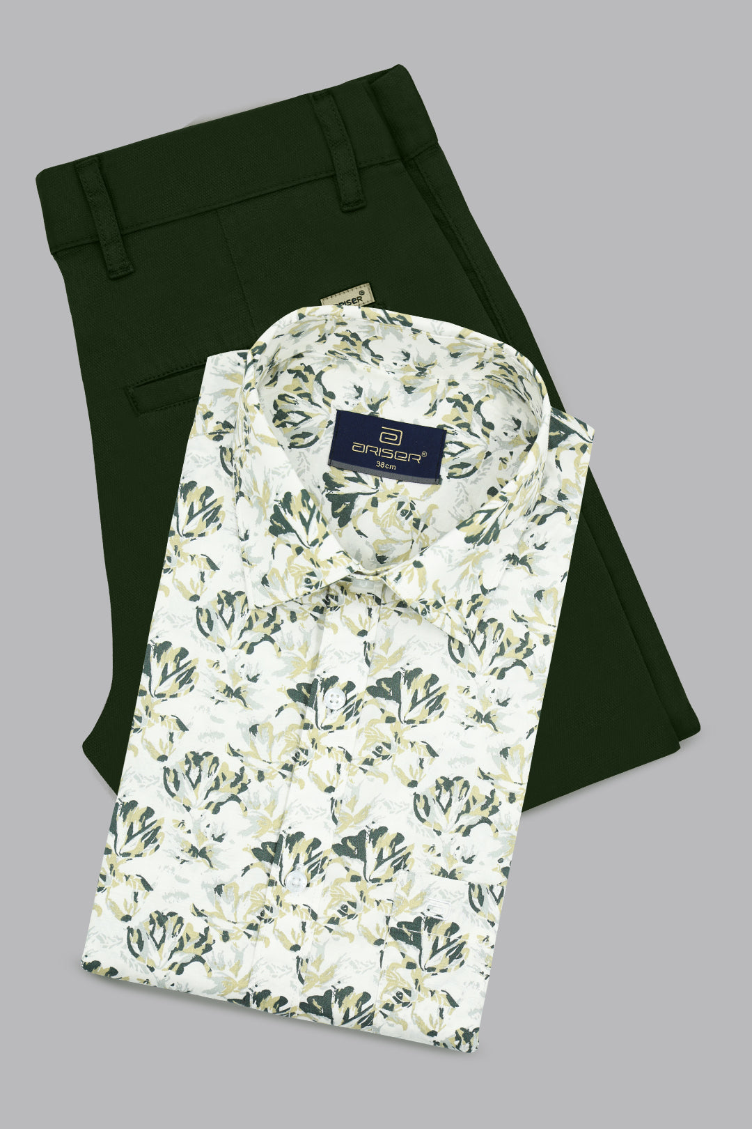 Green pants and a floral-patterned shirt on a gray background