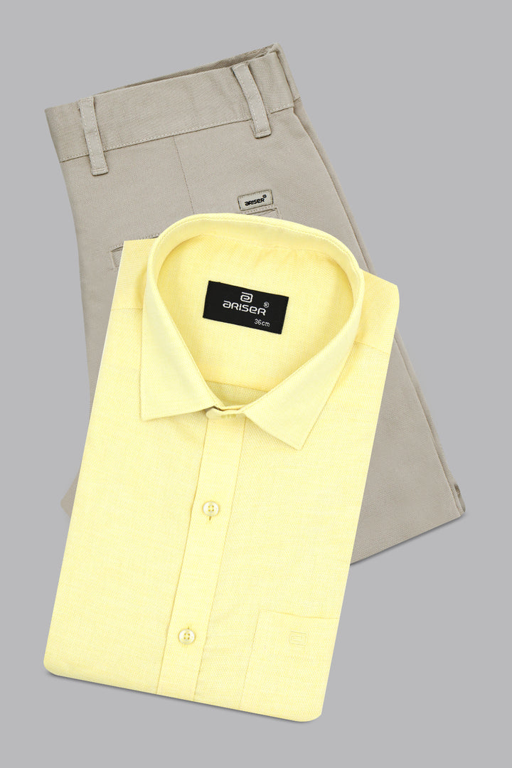 Yellow dress shirt and beige pants on a gray background
