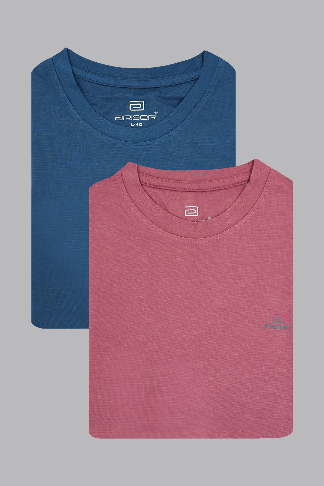 Two folded t-shirts, one blue and one pink, on a gray background.